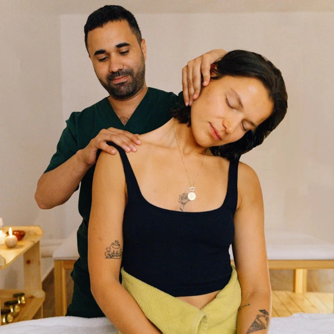 Massage therapist working on a guest's shoulder
