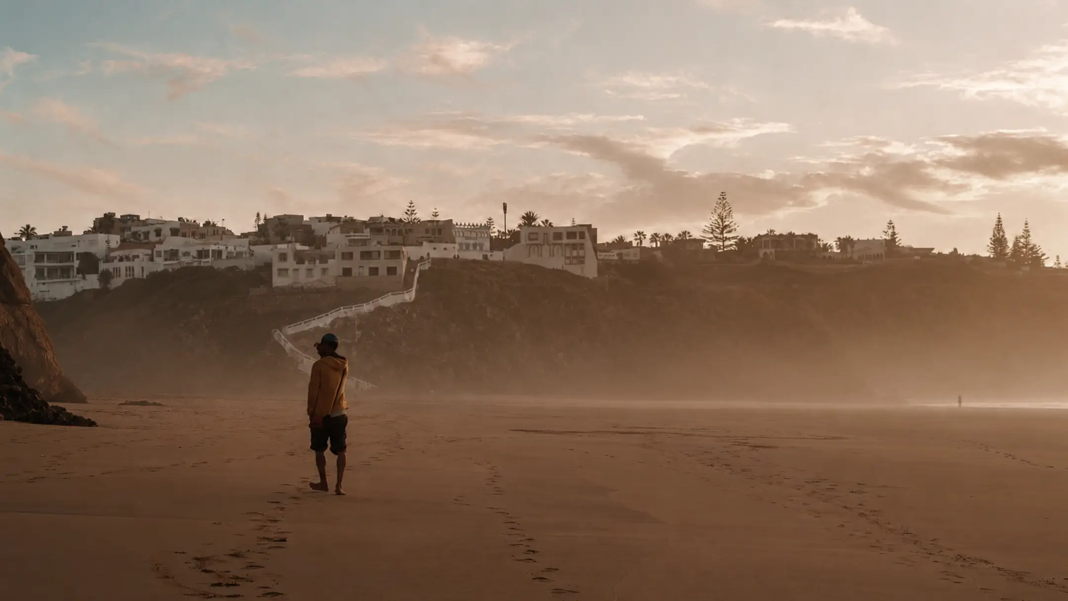 Person taking a quiet morning walk along the beach