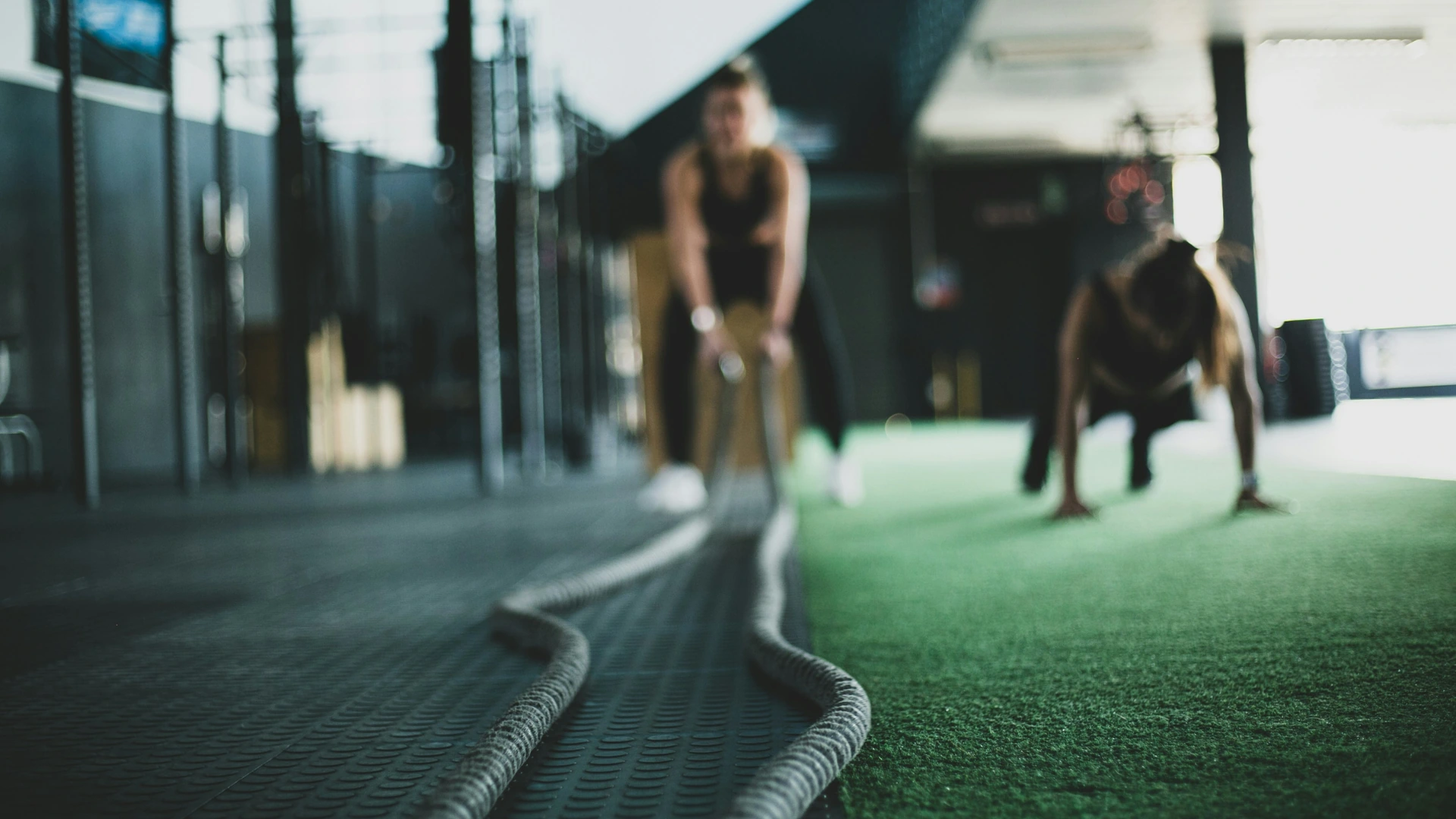 Strength training session with battle ropes in a gym