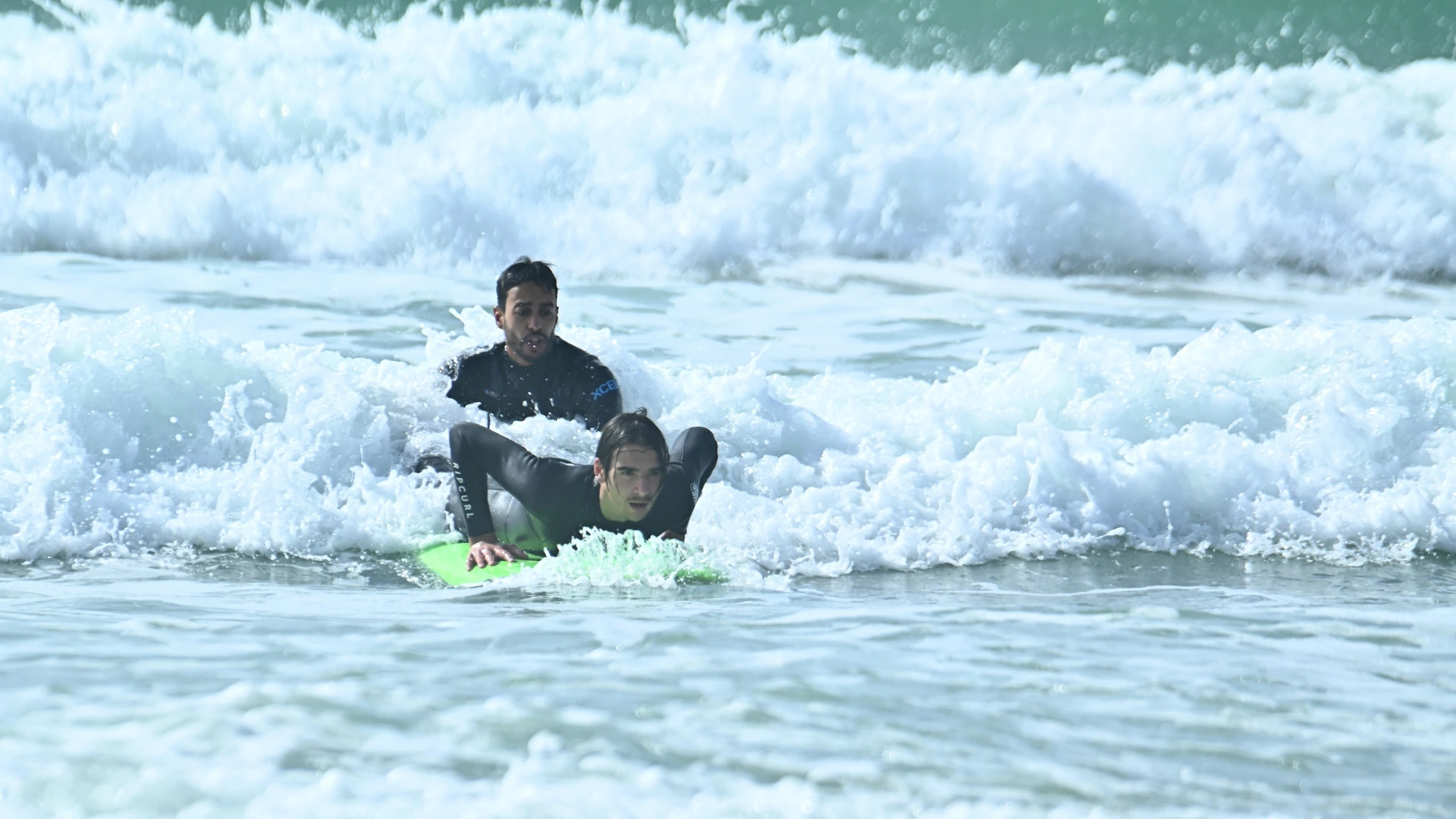Surfer riding a small wave during a surf session