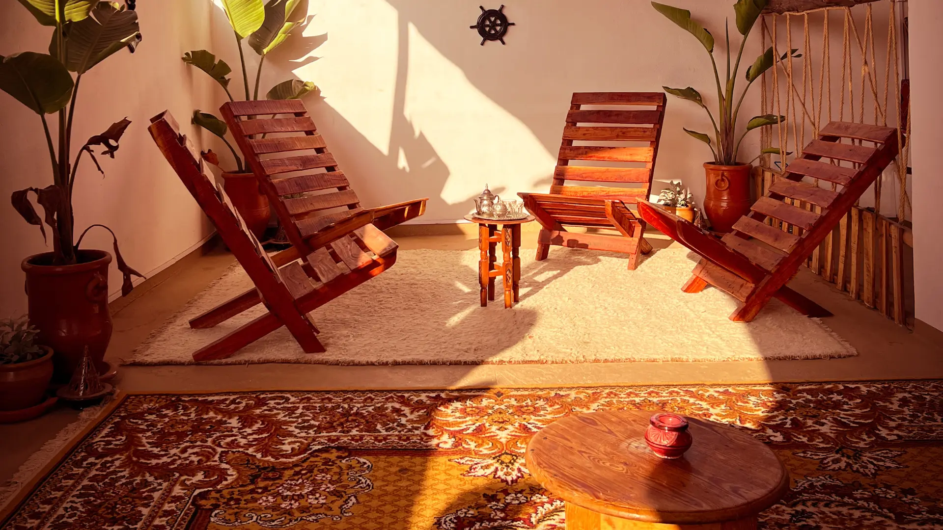 Rooftop terrace at Vagusta Reset with wooden seating and woven rugs