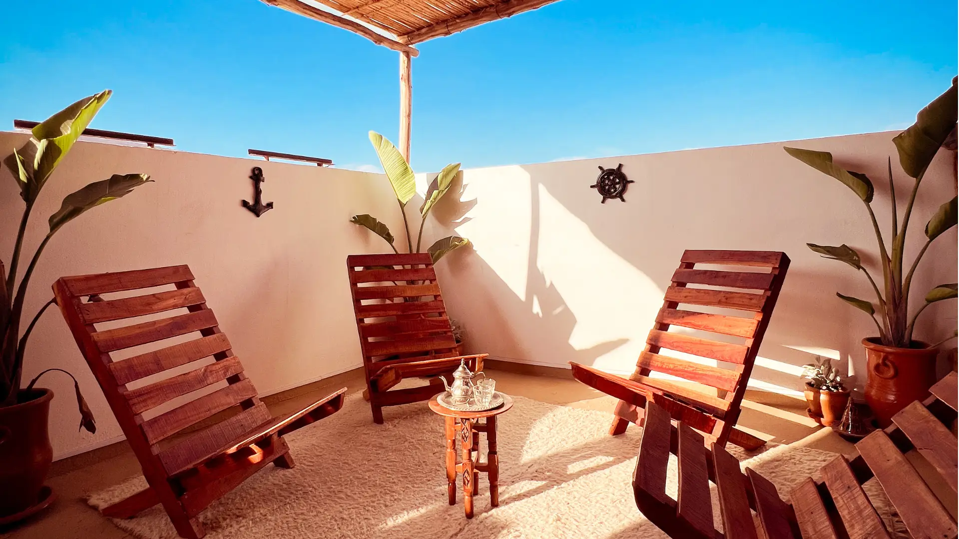 Rooftop terrace at Vagusta Reset with wooden chairs and shaded seating