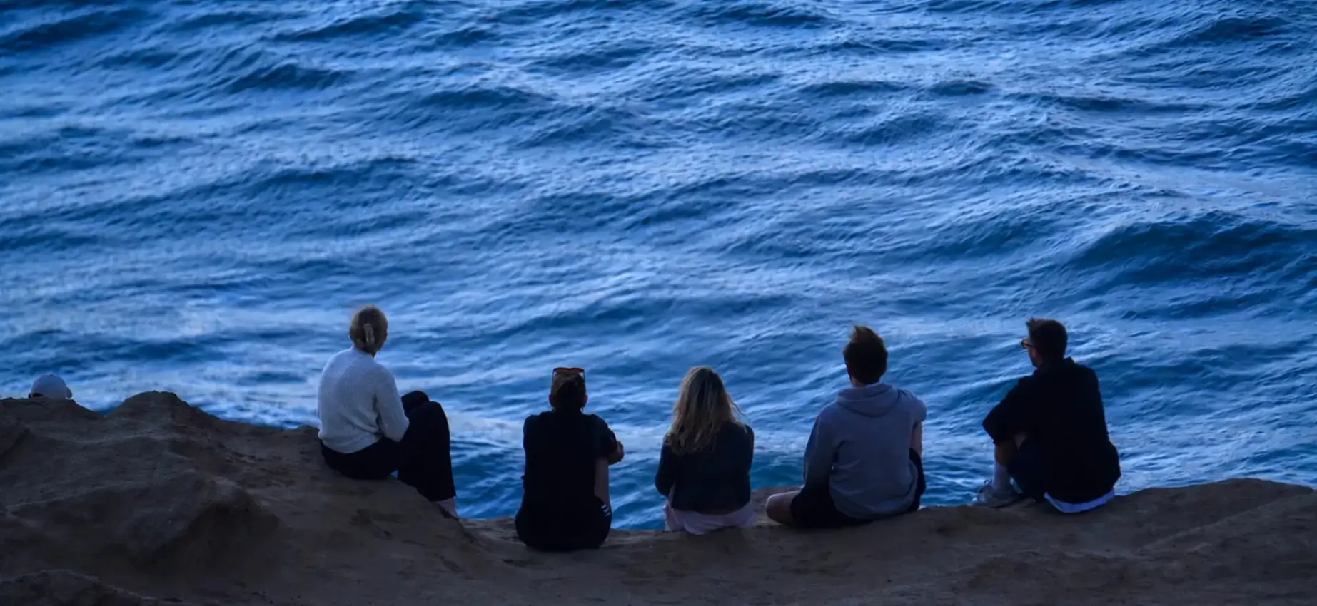 Small group sharing a quiet moment overlooking the Atlantic Ocean