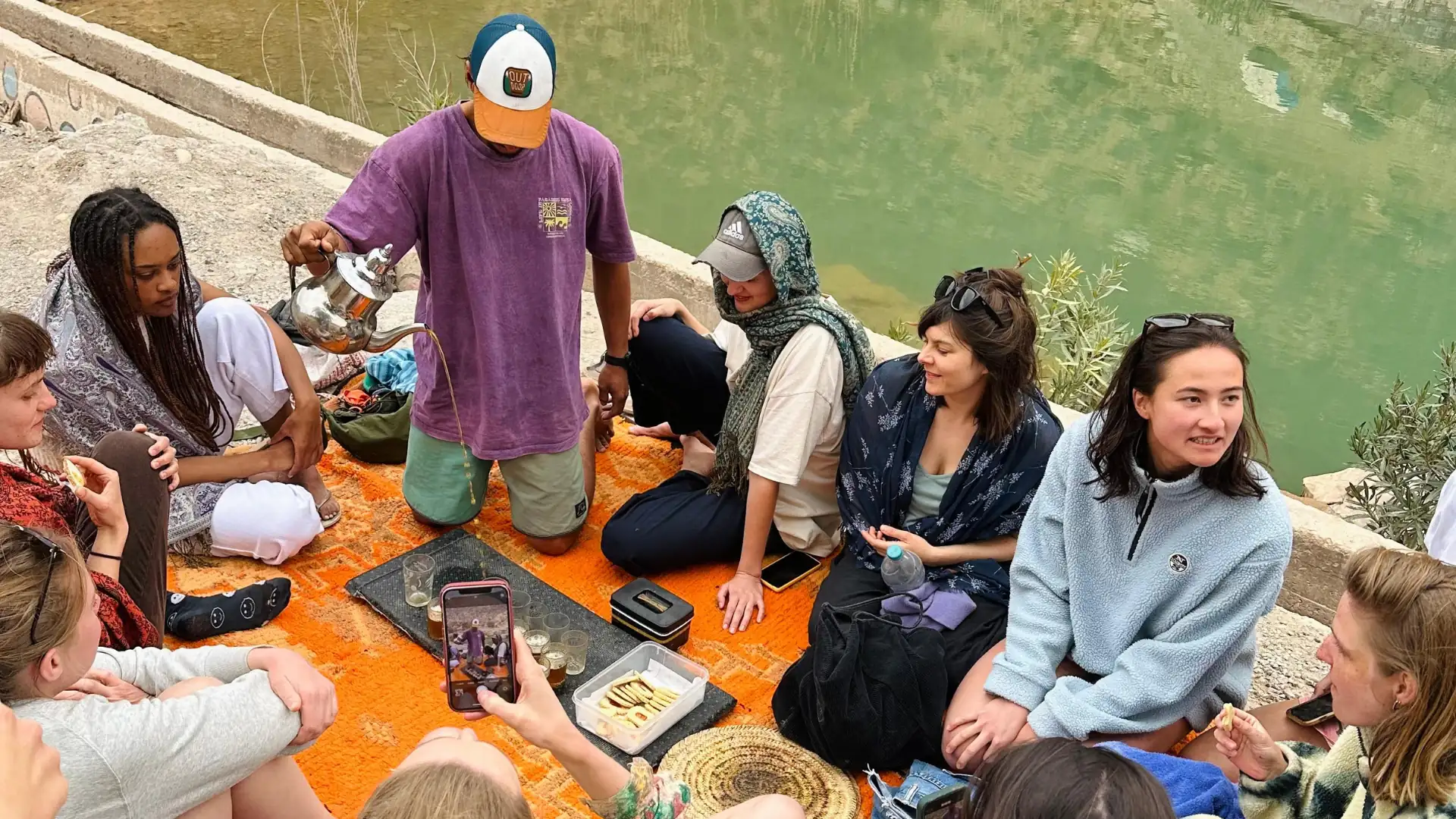 Guests gathered by the water while tea is being served
